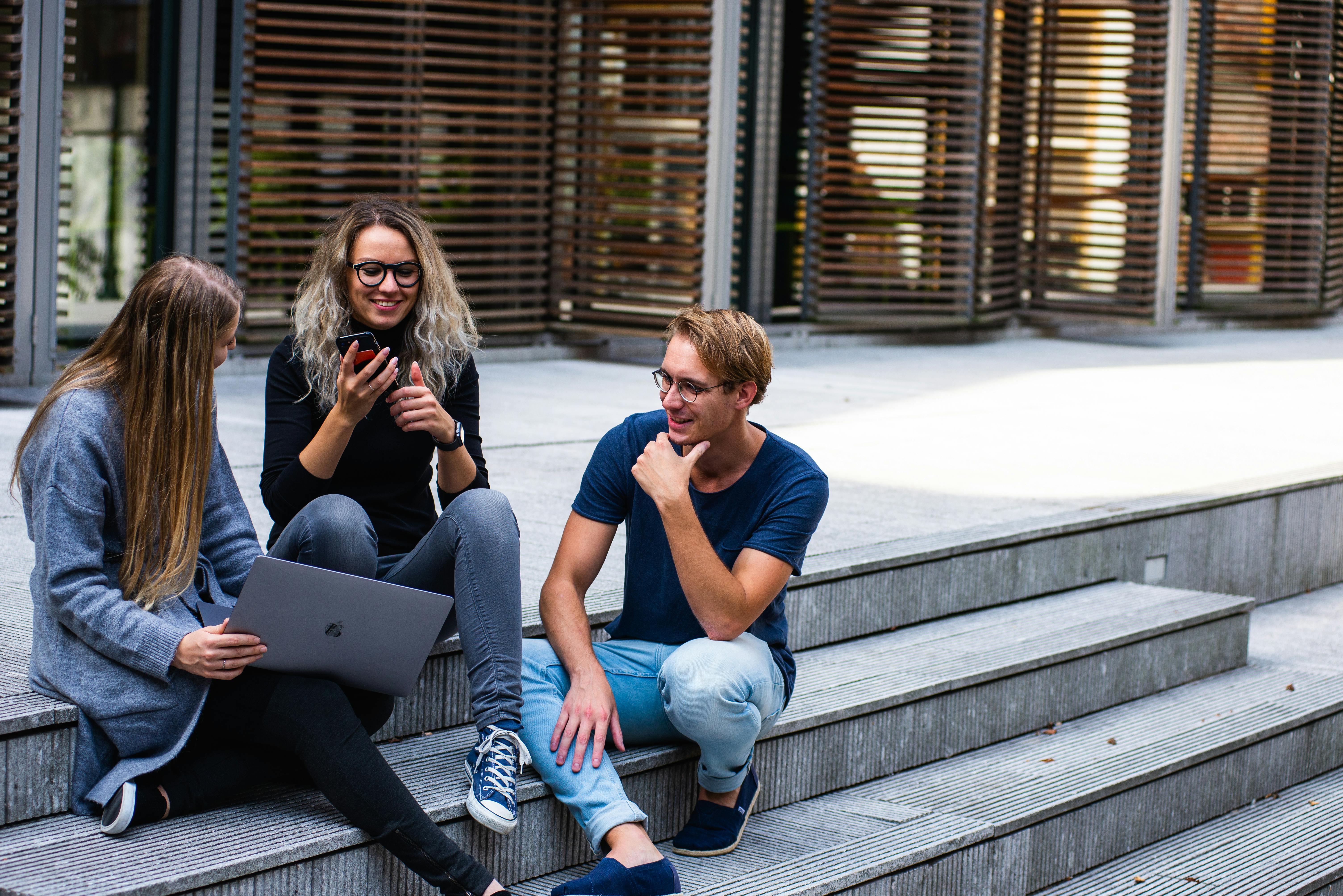 A group of diverse professionals talking and collaborating in a modern office.